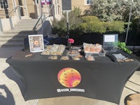 a table with a lot of food on it in front of a building